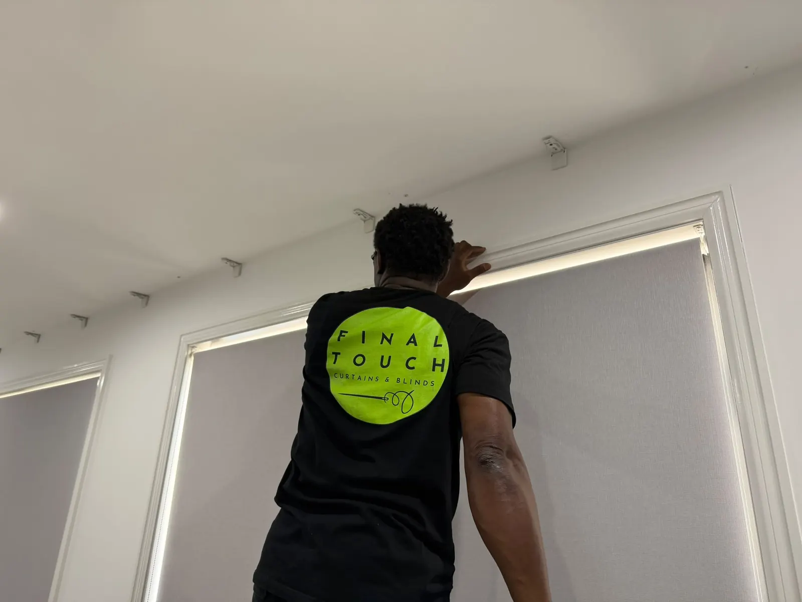 Final Touch team member fitting a curtain track