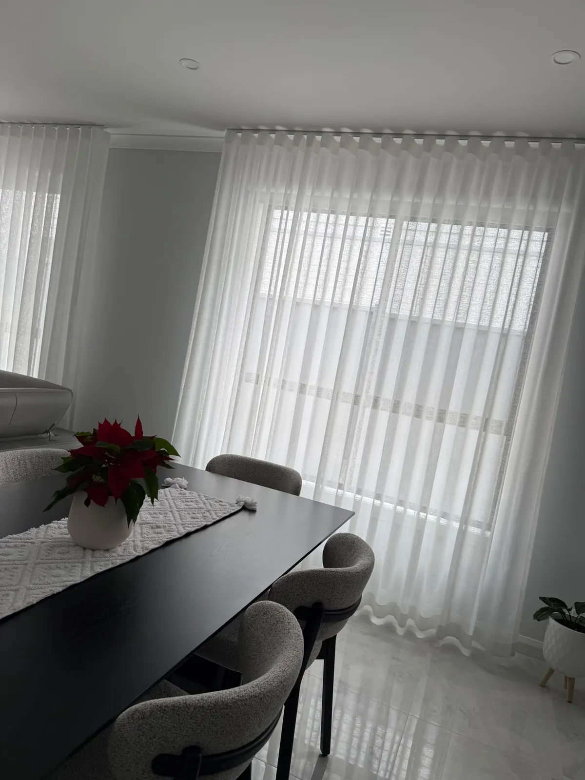 Sheer curtains beside a dining area
